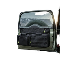 Thumbnail for DEFENDER TACTICAL STORAGE tailgate organizer system on a vehicle with a mountainous landscape in the background.